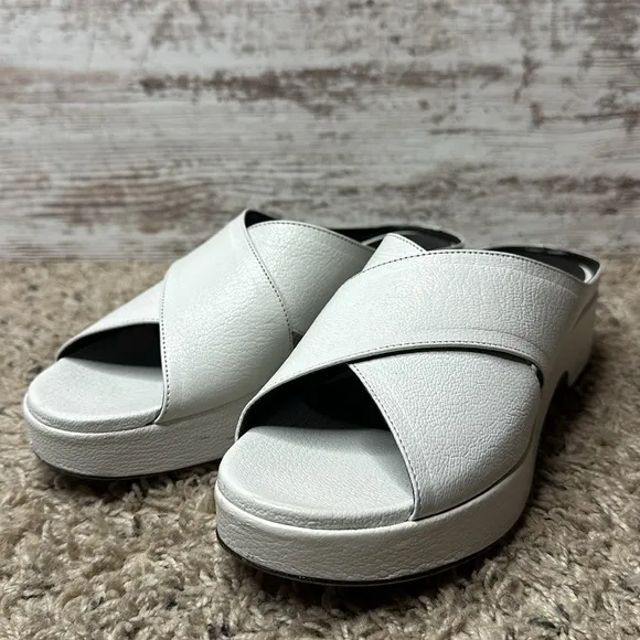 By Far Iggy Mules cross-front platform sandals in white leather