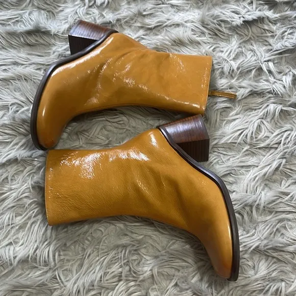 Intentionally blank patent leather heeled boots