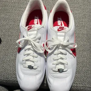 Nike Sneakers White and Red with Perforated Toe Box and Iconic Swoosh