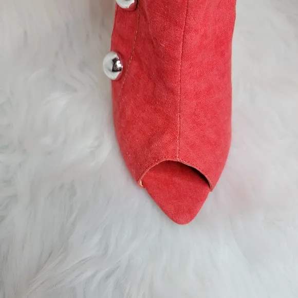 Red boots stiletto heel open toe silver studs.